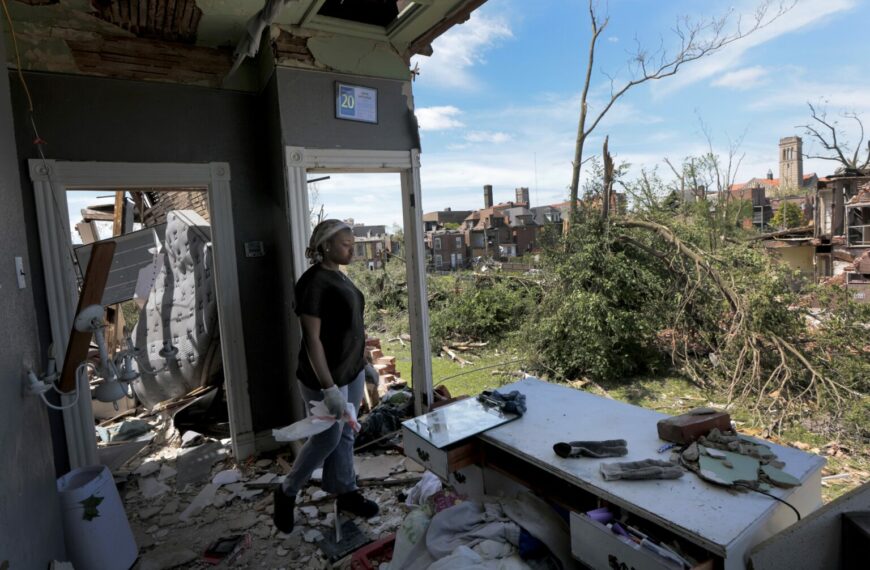 Deadly Storms Strike Midwest and South, Leaving 26 Dead So Far (Photo: "I have never seen anything like this," said Jerikah McCloud, 23, who looks out the destroyed second floor of her family home in the Academy neighborhood of St. Louis, Mo., on Saturday, May 17, 2025, after the National Weather Service confirmed a tornado struck the city on Friday. (Laurie Skrivan/St. Louis Post-Dispatch via AP)