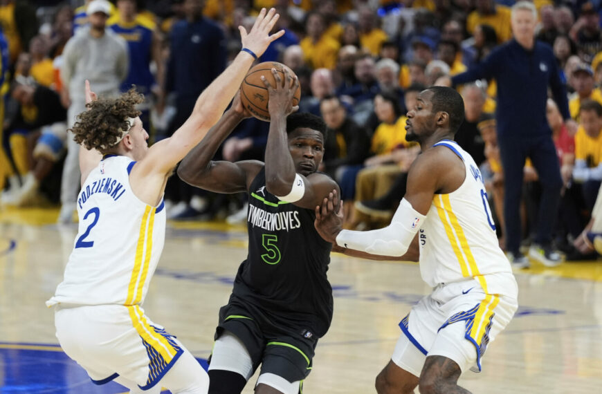 Edwards, Randle Lead Timberwolves to 102-97 Win Over Warriors (Photo: Minnesota Timberwolves guard Anthony Edwards, center, moves the ball between Golden State Warriors guard Brandin Podziemski (2) and forward Jonathan Kuminga during the second half of Game 3 of an NBA basketball second-round playoff series Saturday, May 10, 2025, in San Francisco. (AP Photo/Godofredo A. Vásquez)