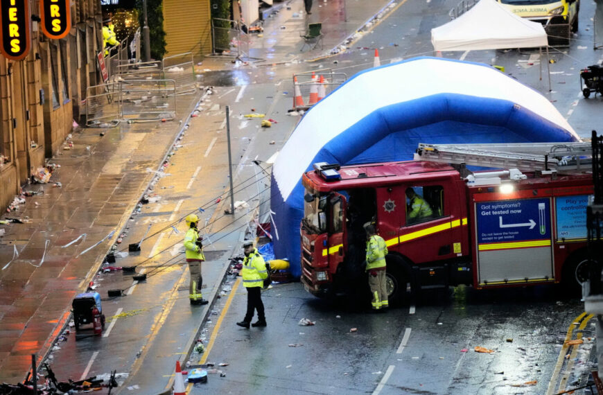 Liverpool Parade Crash Leaves 50 Injured, No Terror Link (Photo: Police and emergency personnel walk next to a tent at the site of an incident on Water Street near the Liver Building in Liverpool after a car collided with pedestrians during the Premier League winners parade, in Liverpool, England, Monday May 26, 2025. (Danny Lawson/PA via AP)