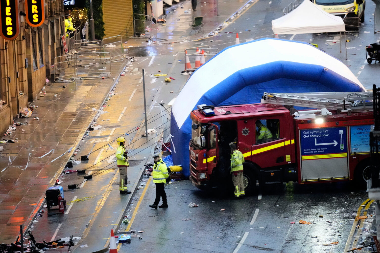 Liverpool Parade Crash Leaves 50 Injured, No Terror Link (Photo: Police and emergency personnel walk next to a tent at the site of an incident on Water Street near the Liver Building in Liverpool after a car collided with pedestrians during the Premier League winners parade, in Liverpool, England, Monday May 26, 2025. (Danny Lawson/PA via AP)