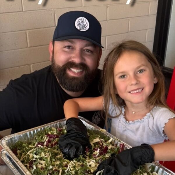 Michael Duarte cooking BBQ in his kitchen